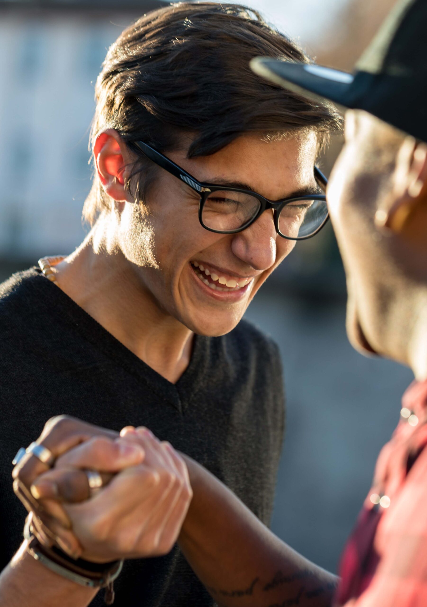 good friends joking about their secret handshake